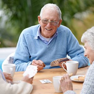 A group of senior citizens playing cards together